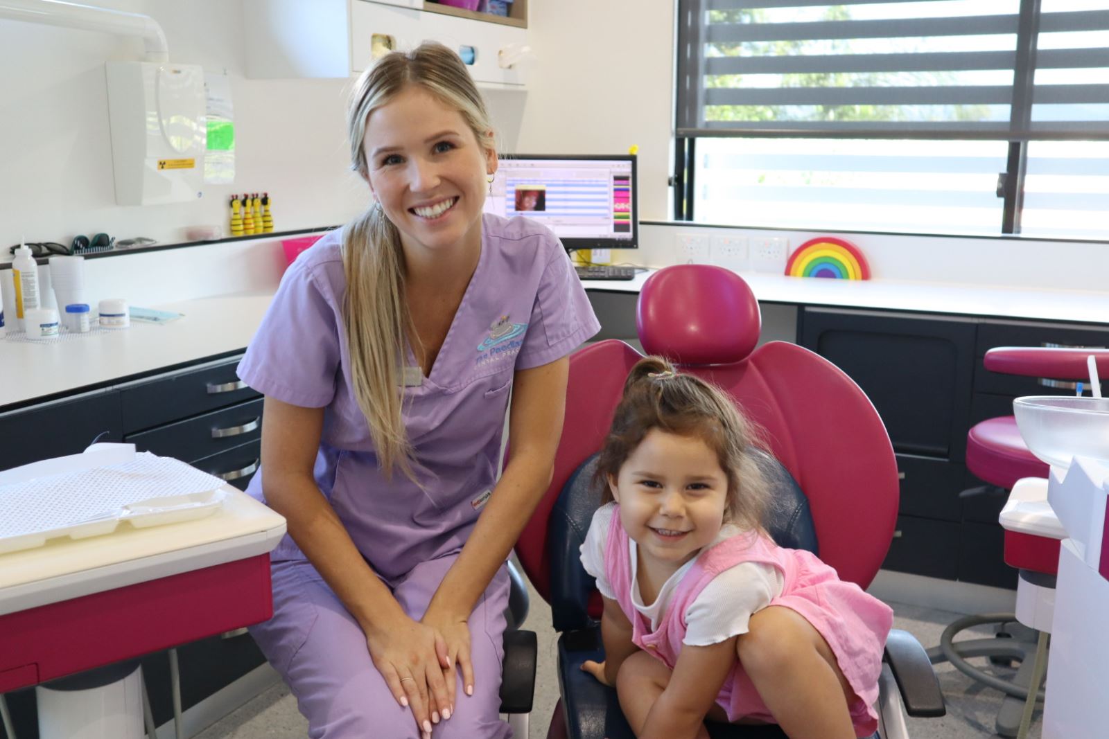 Child on dental chair brushing her teeth