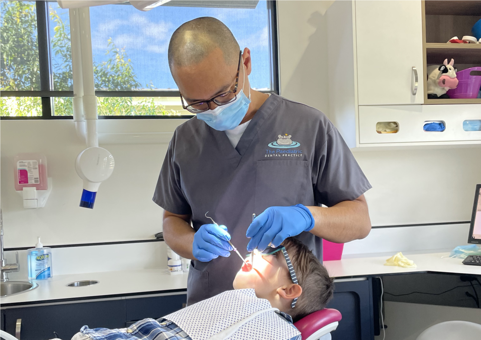 Child brushing teeth facing dentist in Benowa 