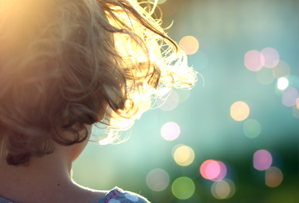 Back view of child dental patient facing colored lights